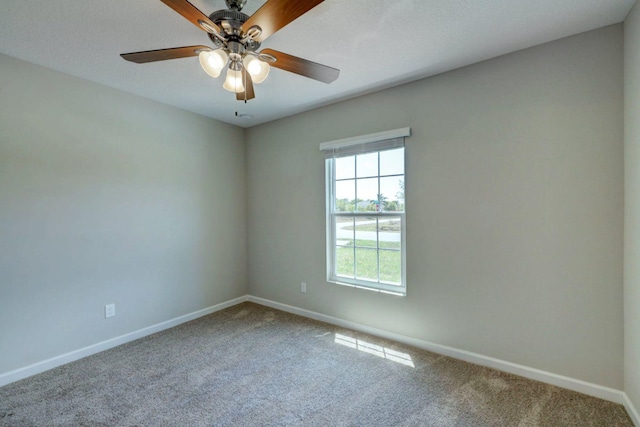 spare room featuring ceiling fan and carpet