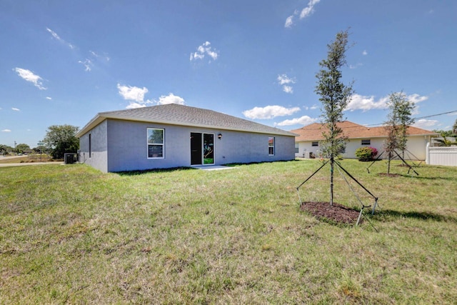 rear view of property with a yard