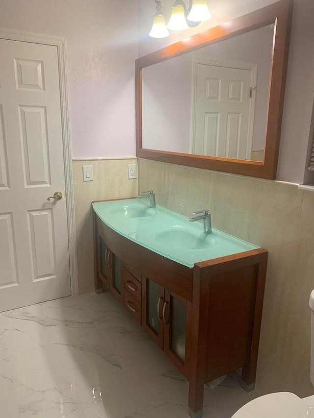 bathroom featuring vanity and toilet