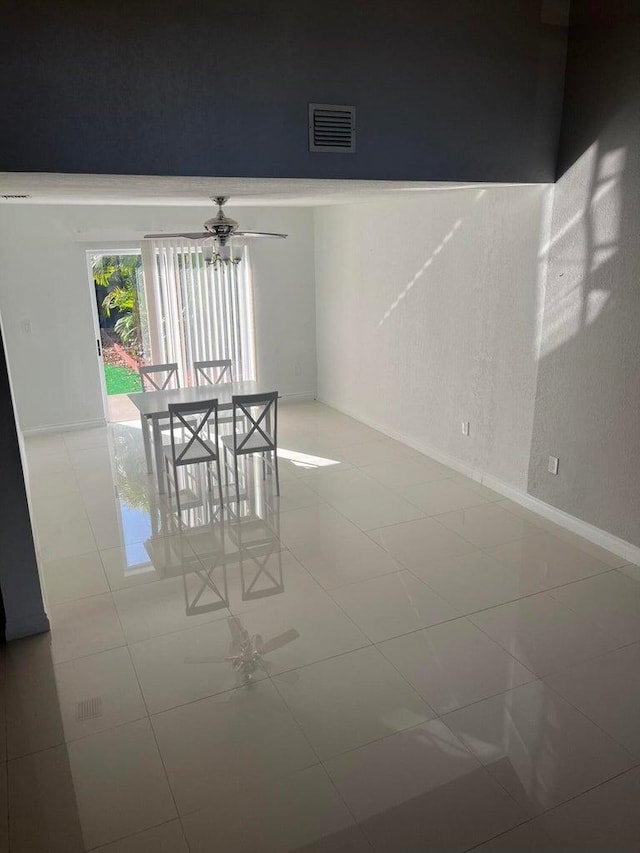 tiled dining room featuring ceiling fan