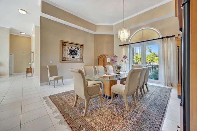 dining space with a high ceiling, crown molding, light tile patterned flooring, and a notable chandelier