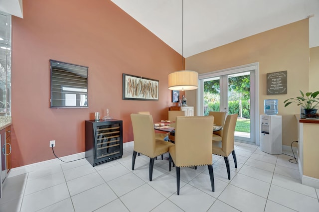 dining space featuring lofted ceiling, light tile patterned floors, and beverage cooler