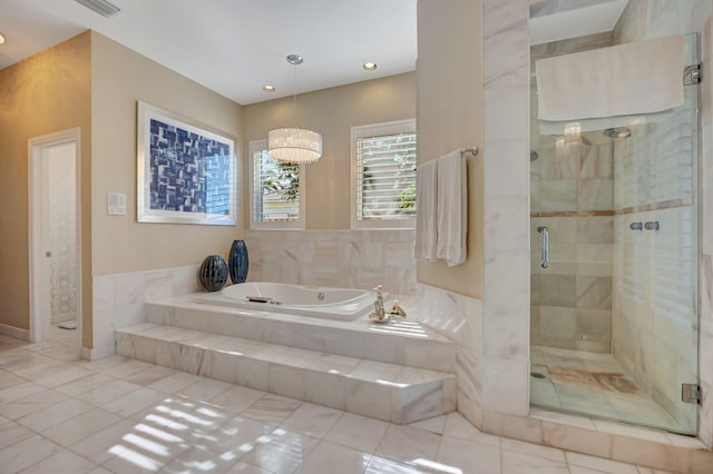 bathroom featuring independent shower and bath