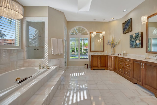 bathroom with tile patterned flooring, vanity, and separate shower and tub