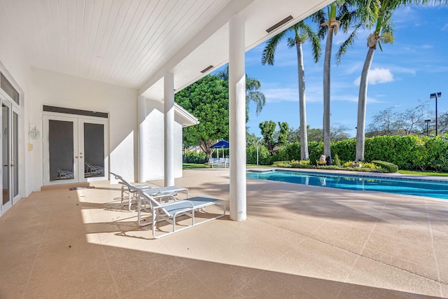 view of pool with a patio area and french doors