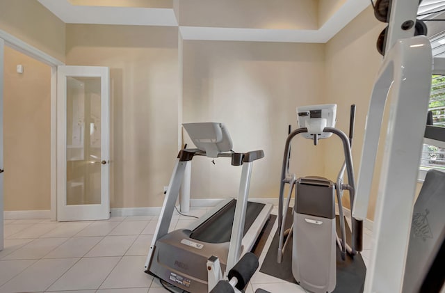 workout area featuring plenty of natural light and light tile patterned floors