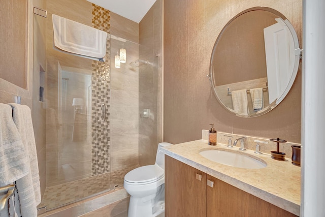 bathroom featuring vanity, toilet, tile patterned flooring, and a shower with door