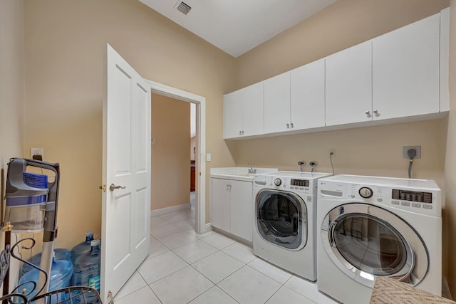 laundry room with cabinets, sink, light tile patterned floors, and independent washer and dryer