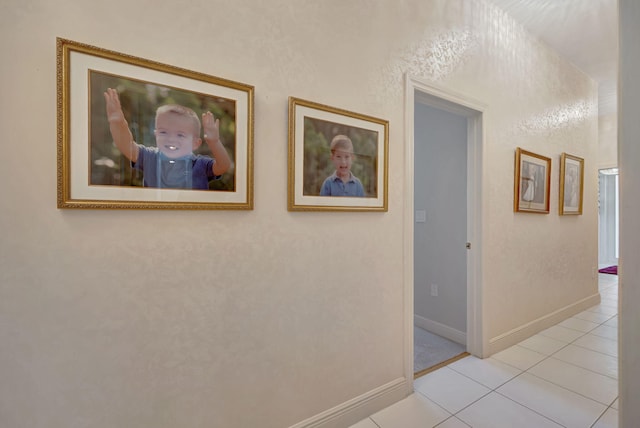 hall featuring light tile patterned flooring