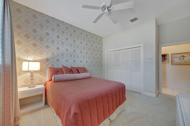 bedroom with light colored carpet, a closet, and ceiling fan