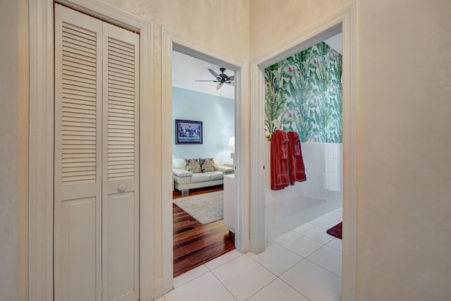 hall featuring lofted ceiling and light tile patterned floors