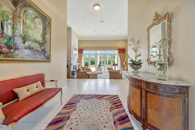 hallway featuring light tile patterned flooring and french doors