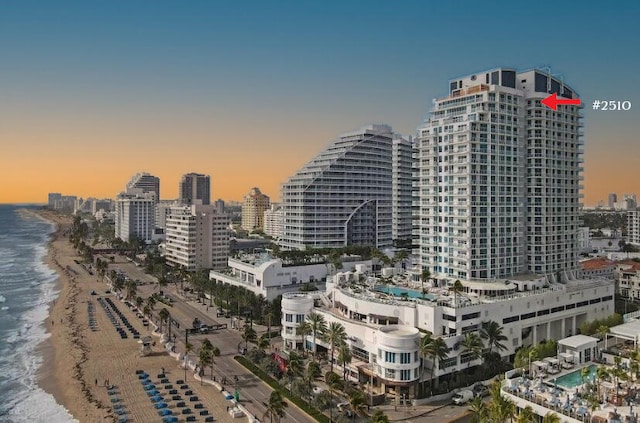 property's view of city featuring a water view and a view of the beach