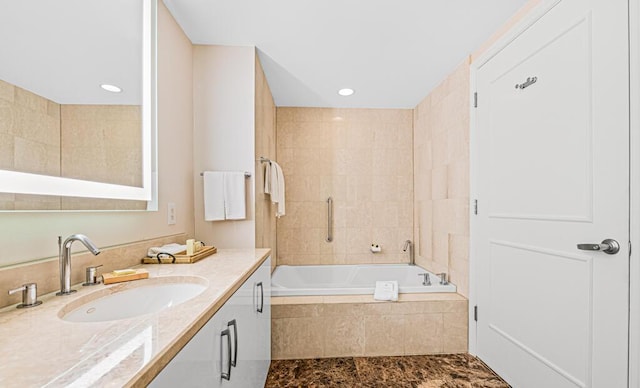 bathroom featuring vanity and shower with separate bathtub