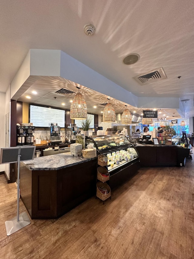 interior space featuring hardwood / wood-style flooring and stone countertops