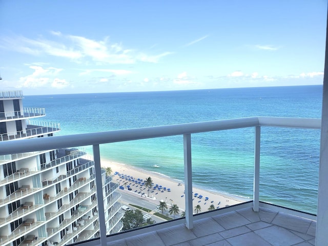 balcony with a water view and a beach view