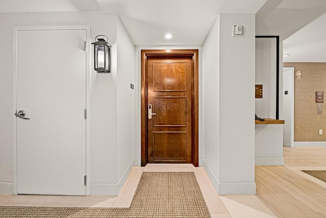 hall with light tile patterned floors