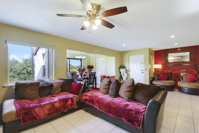 tiled living room with ceiling fan with notable chandelier