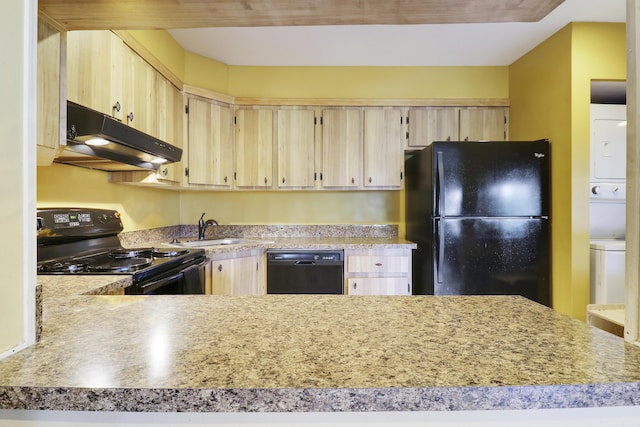 kitchen featuring sink, stacked washer / drying machine, black appliances, light brown cabinetry, and kitchen peninsula