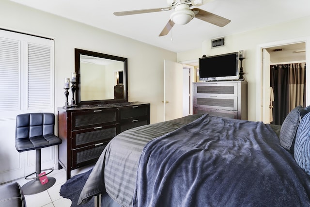 tiled bedroom featuring ceiling fan