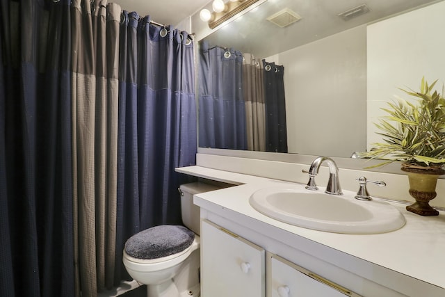 bathroom featuring vanity, toilet, and a shower with shower curtain