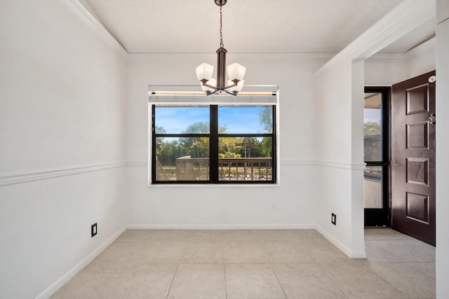 unfurnished room with light tile patterned flooring, ornamental molding, a textured ceiling, and an inviting chandelier