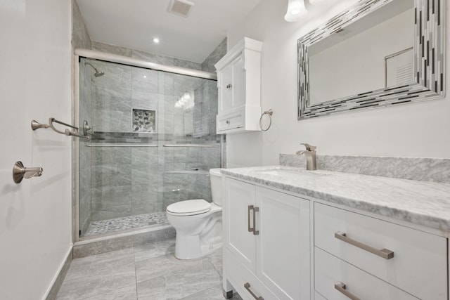 bathroom with vanity, toilet, and walk in shower