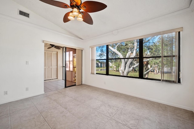 spare room with light tile patterned floors and vaulted ceiling