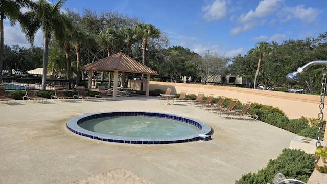 view of swimming pool with a gazebo, a patio area, and a community hot tub