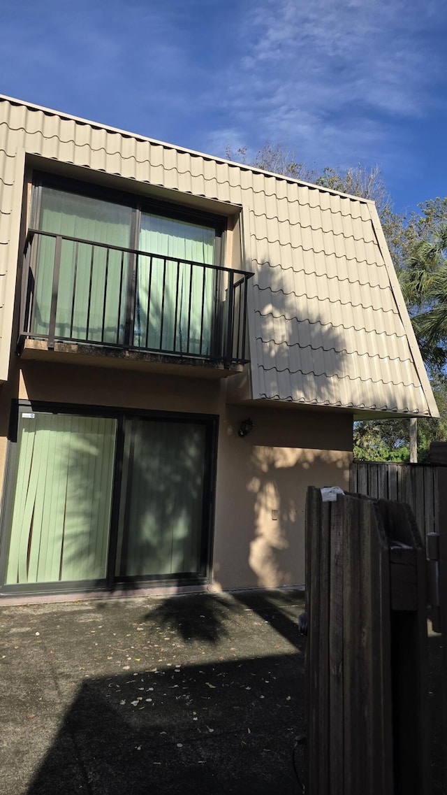 back of house with a balcony