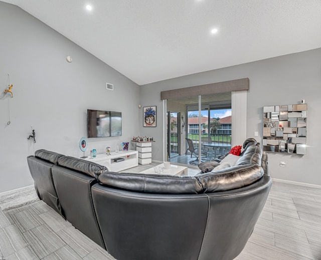 living room featuring lofted ceiling