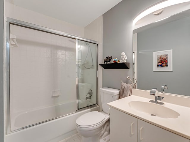 full bathroom with tile patterned flooring, vanity, toilet, and bath / shower combo with glass door