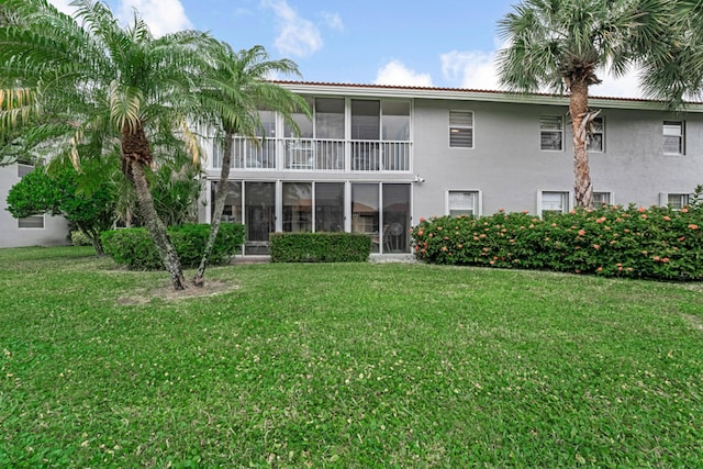 rear view of property with a yard