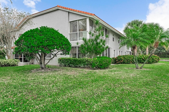 view of side of property with a yard