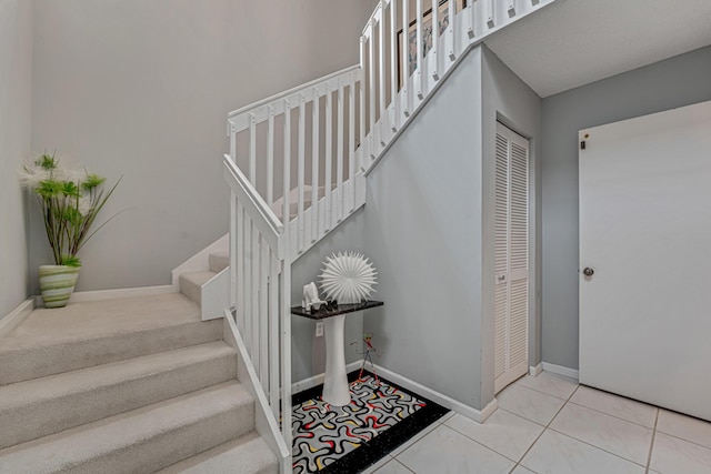 stairs with tile patterned floors