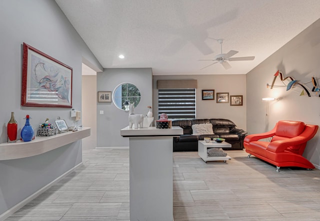 interior space with a textured ceiling and ceiling fan