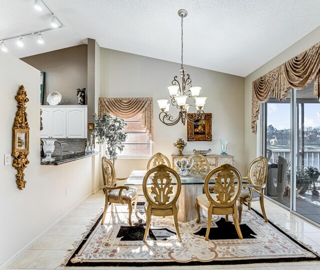 kitchen featuring appliances with stainless steel finishes, white cabinetry, vaulted ceiling, and sink