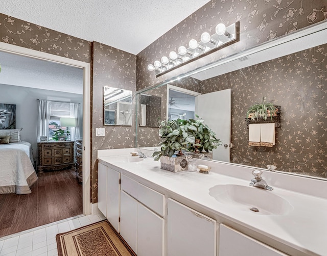 9817 Seacrest Cir Unit 201, Boynton Beach, FL 33437 - bedroom with a textured ceiling, baseboards, a ceiling fan, and light colored carpet