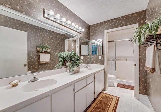 bedroom featuring a textured ceiling, ceiling fan, wood-type flooring, and connected bathroom