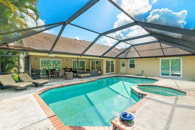 view of pool featuring a patio area, an in ground hot tub, glass enclosure, and an outdoor living space