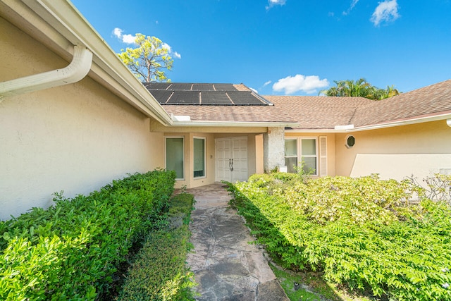 entrance to property featuring solar panels