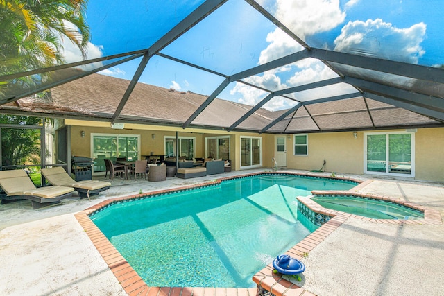 view of pool featuring an in ground hot tub, outdoor lounge area, a lanai, and a patio area