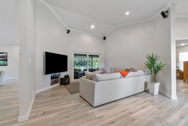 living room featuring light hardwood / wood-style flooring, vaulted ceiling, and crown molding