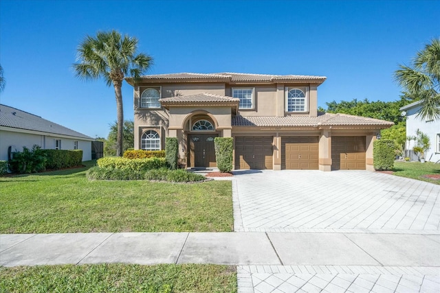 mediterranean / spanish-style house with a front lawn and a garage