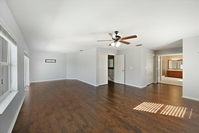 unfurnished living room featuring ceiling fan and dark hardwood / wood-style floors