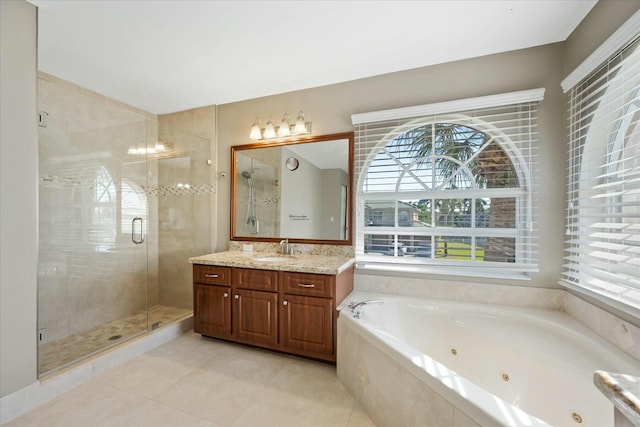 bathroom featuring tile patterned floors, vanity, and shower with separate bathtub