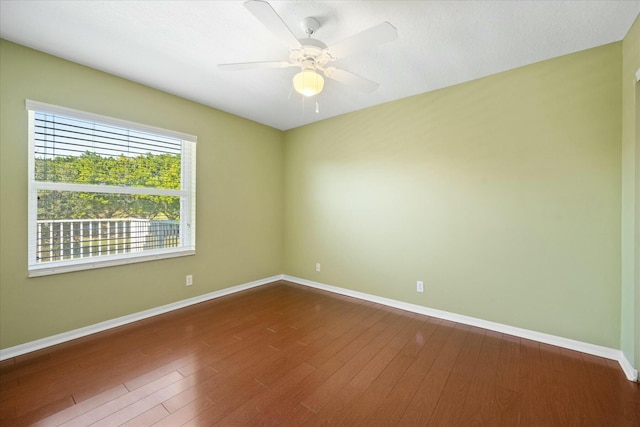 unfurnished room with hardwood / wood-style floors and ceiling fan