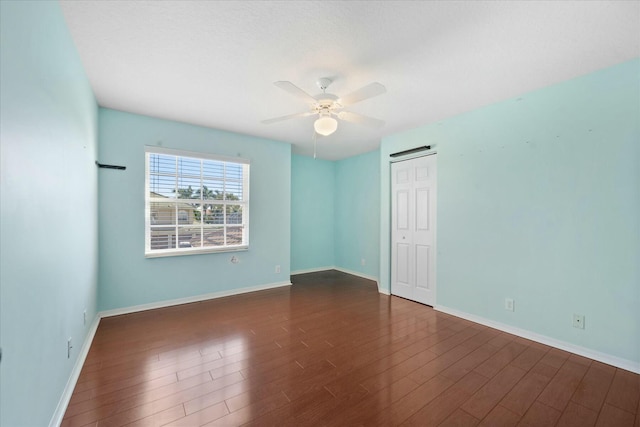 spare room featuring ceiling fan and dark hardwood / wood-style flooring