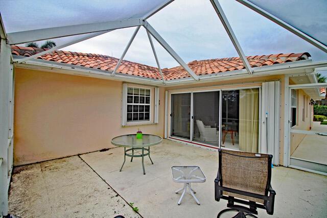 view of patio with glass enclosure