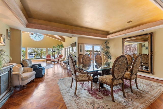 dining area featuring plenty of natural light, a raised ceiling, and visible vents